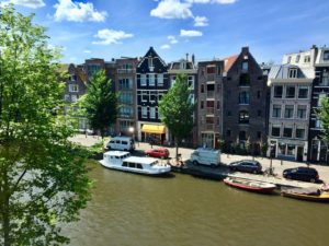 a river with boats and buildings