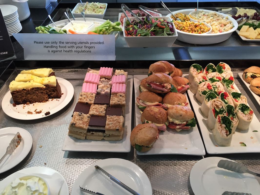 a buffet table with plates of food