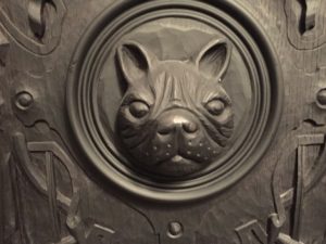 a black dog head carved into a circle