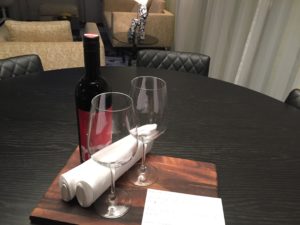 a table with wine glasses and a bottle of wine