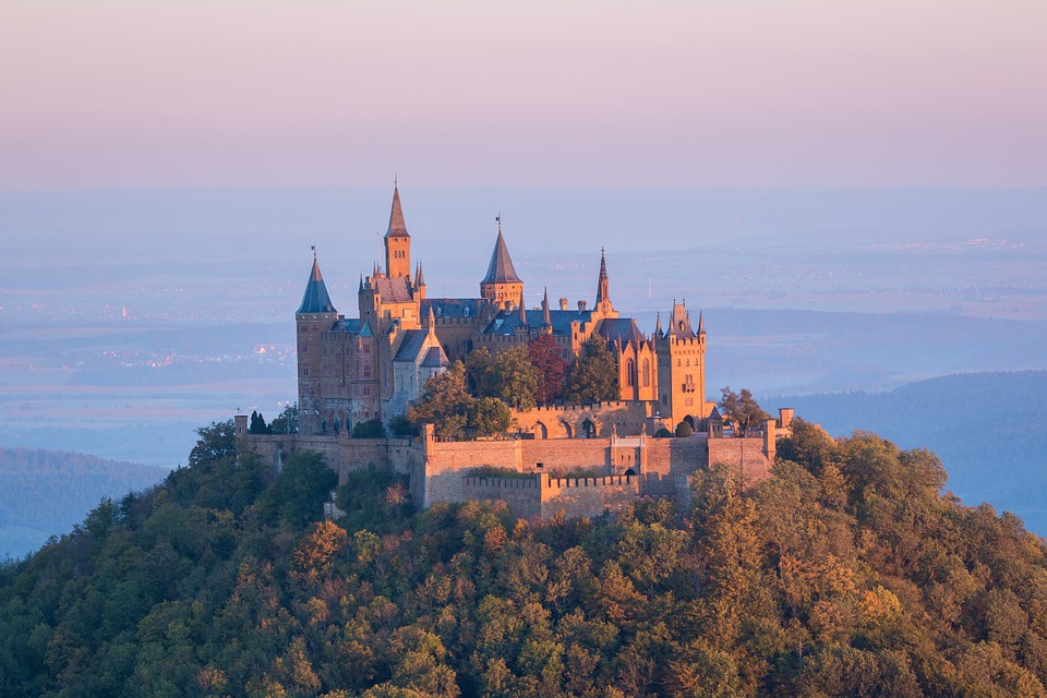 a castle on a hill with Hohenzollern Castle in the background