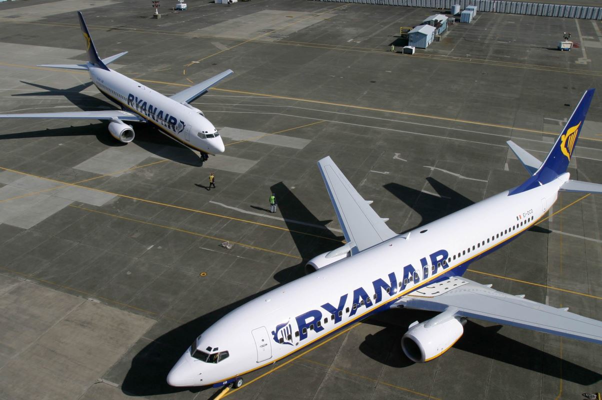 a couple of white airplanes on a tarmac