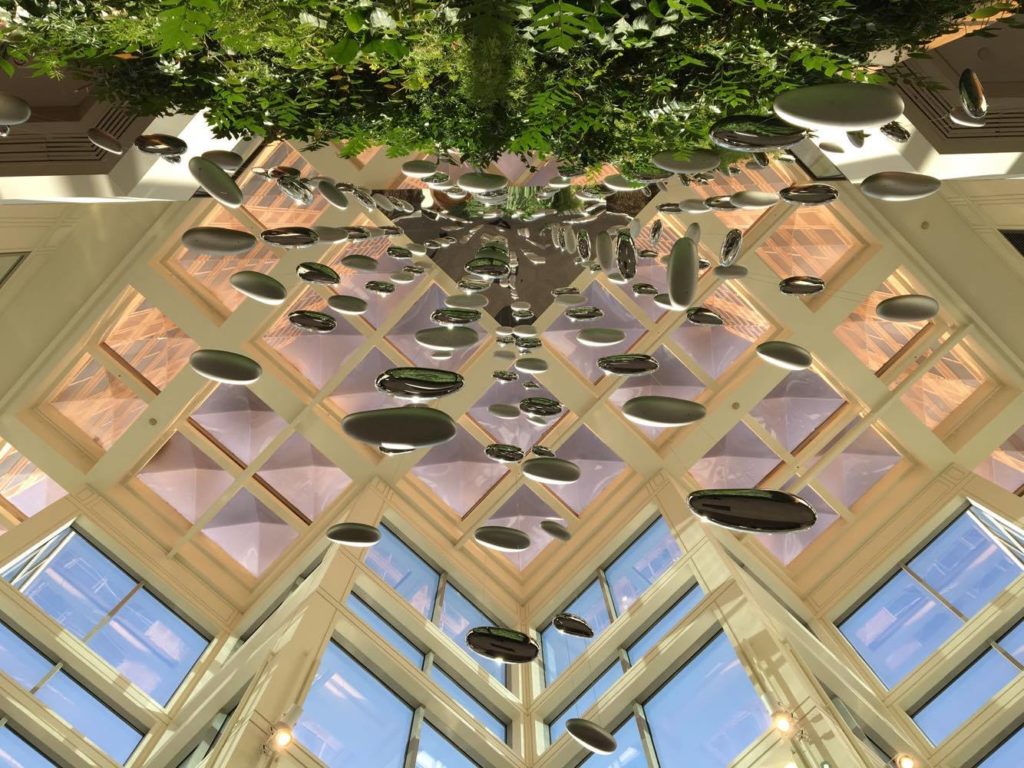 a glass ceiling with many round objects from it