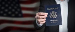 a hand holding a passport