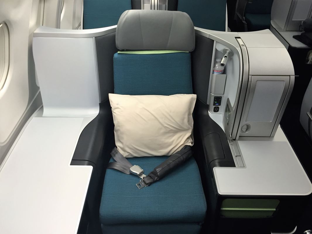 a seat with a pillow and a seat belt on the back