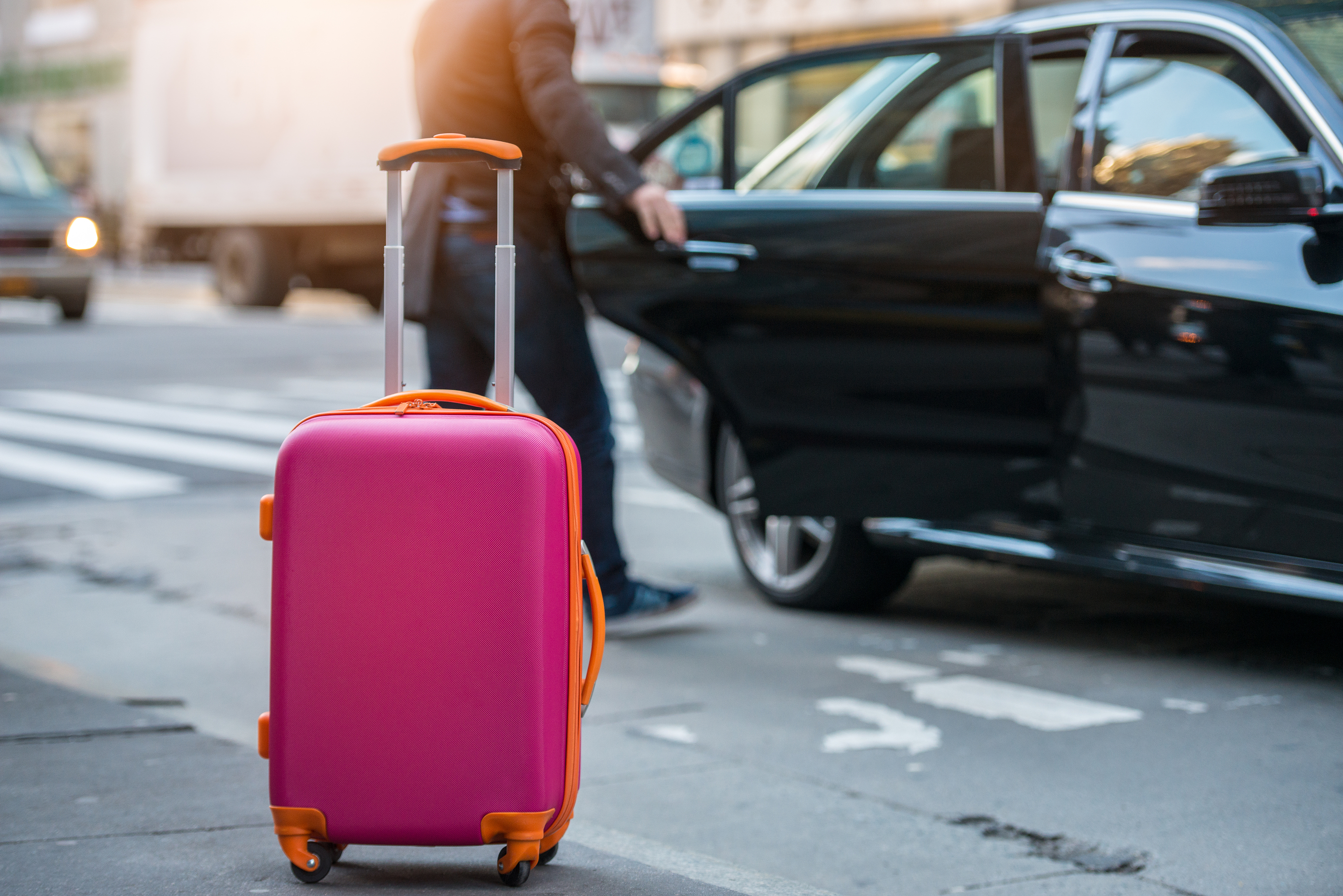 a pink suitcase on the street