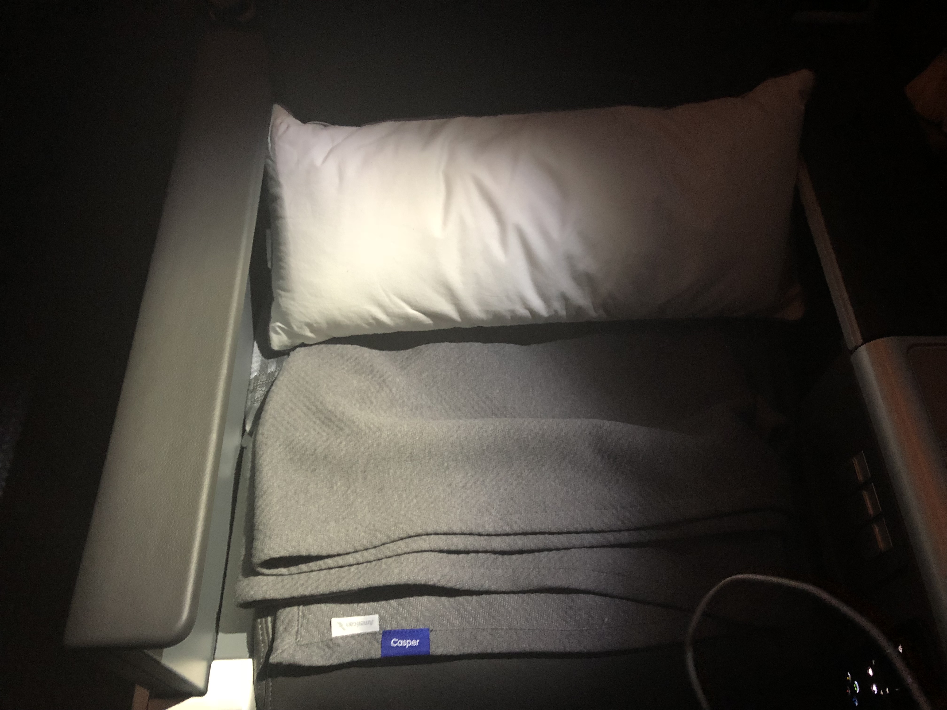 a pillow and blanket on a bed