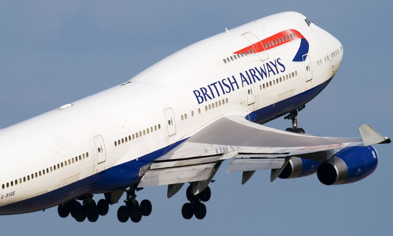 a large white airplane with blue and red text