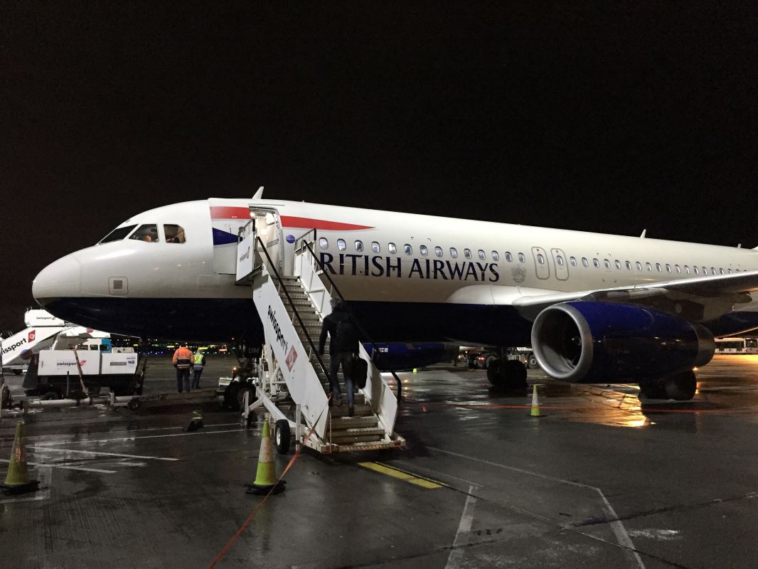 a plane with stairs and people walking up to it