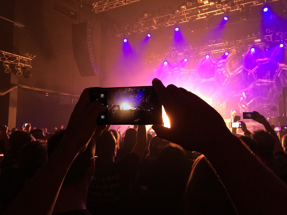 a person taking a picture of a concert