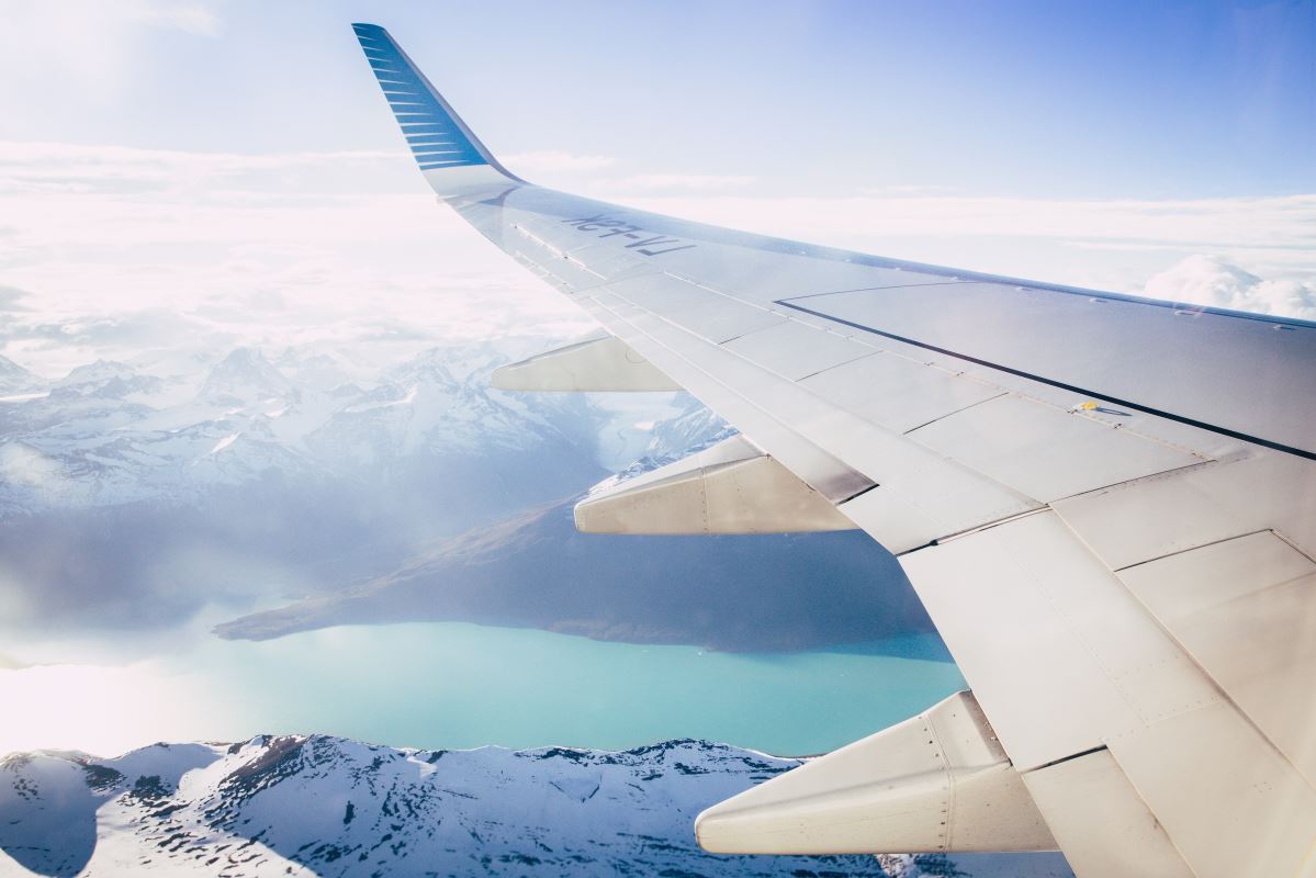 an airplane wing above a body of water