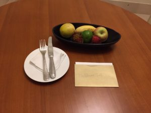 a plate with fruit and fork on a table