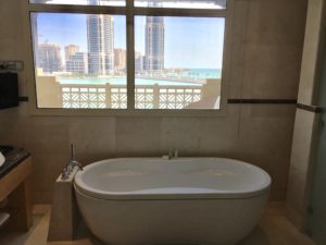 a bathroom with a tub and a window