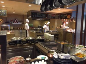 a kitchen with chef in the background