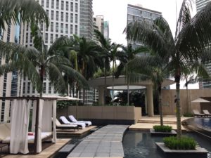 a pool with lounge chairs and palm trees