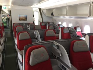 a row of red and grey seats in an airplane