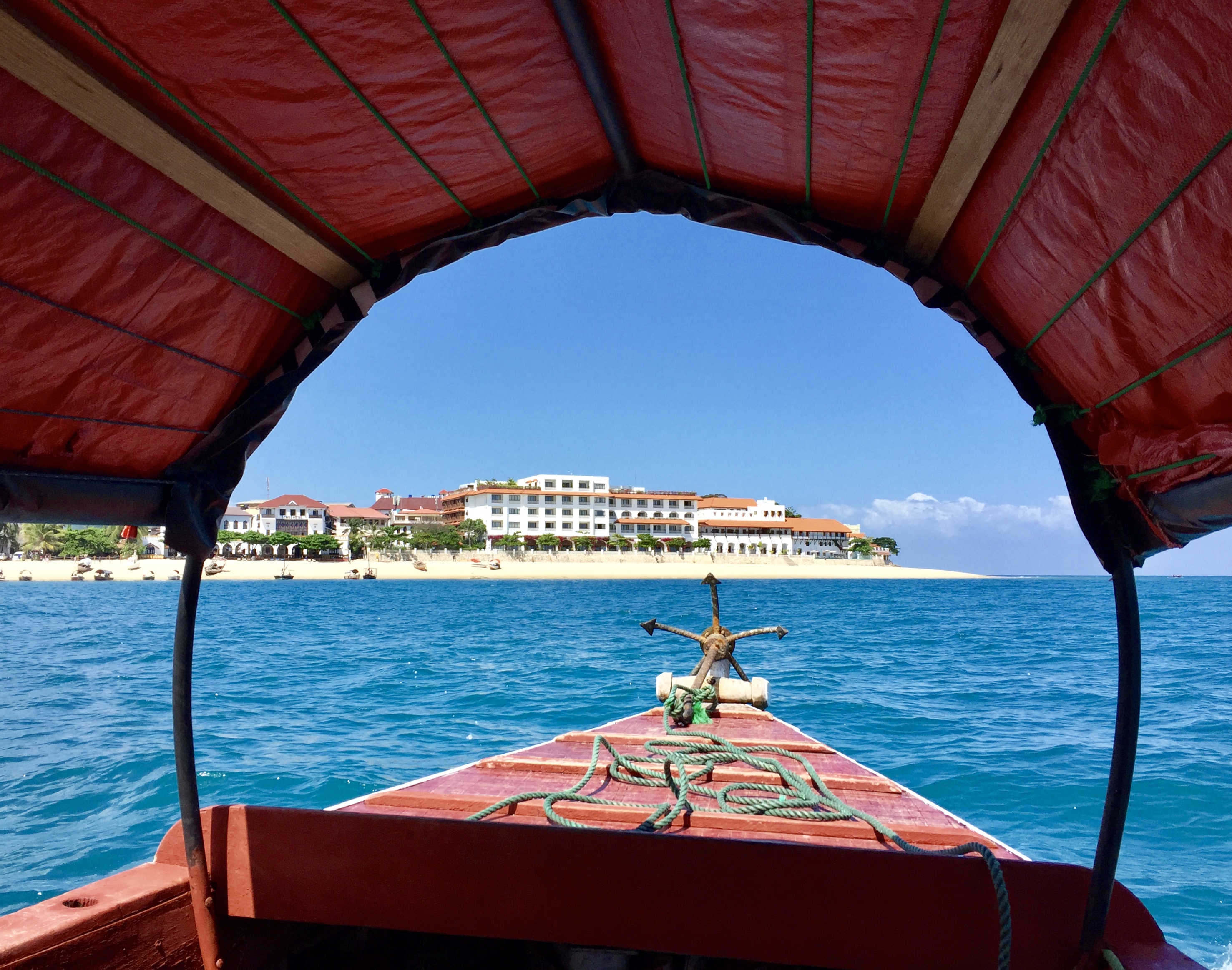 a view from a boat of a beach and a building from the front of it