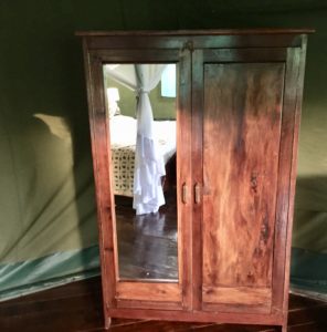 a wooden cabinet with a mirror