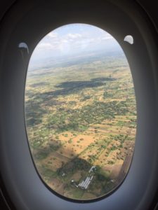 an airplane window with a landscape