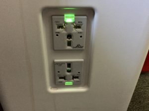 a wall outlet with green lights
