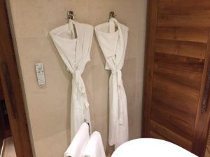 a pair of white robes on hooks