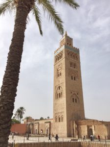a tall building with a palm tree