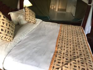a bed with pillows and a canopy