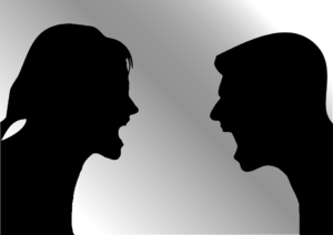silhouette of a man and woman yelling at each other