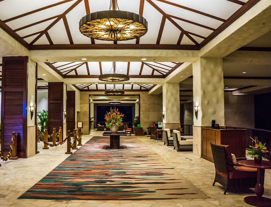 a lobby with a rug and chairs