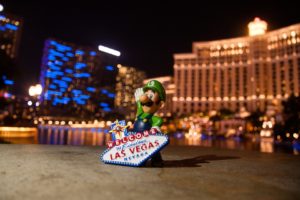 a toy figurine of a man in front of a casino