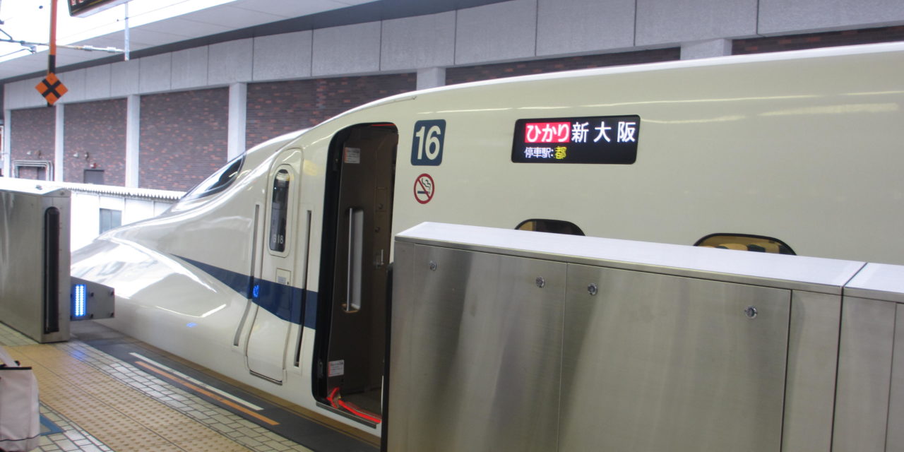 a white train with a blue stripe