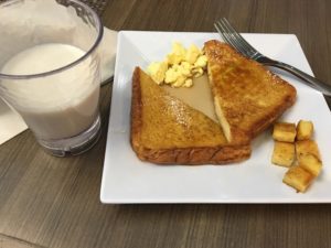 a plate of french toast and eggs