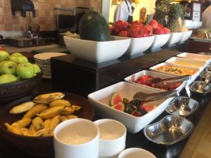 a buffet table full of fruit and vegetables