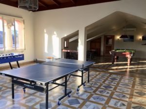 a room with ping pong tables and pool table