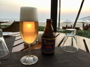 a glass of beer and a bottle on a table