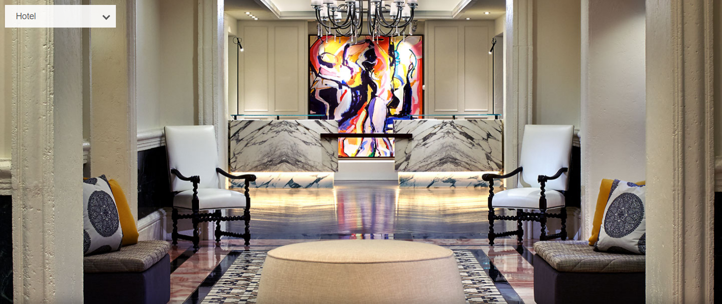 a lobby with a large painting on the wall