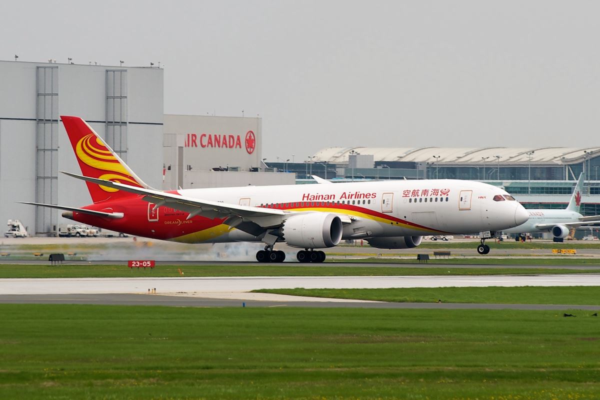 a red and yellow airplane on a runway