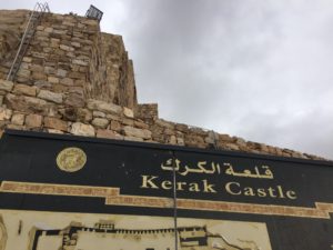 a sign on a stone wall