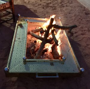 a fire pit on the sand