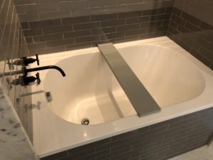 a bathtub with a black faucet