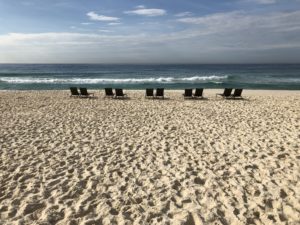 a row of chairs on a beach