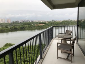 a balcony with a table and chairs overlooking a body of water