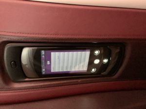 a phone on the armrest of a car