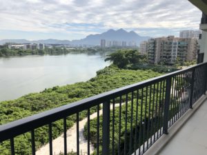 a balcony overlooking a body of water and trees