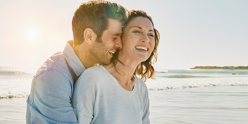 a man and woman smiling at the camera