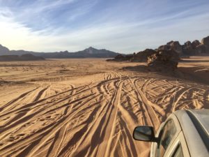 a car driving through a desert