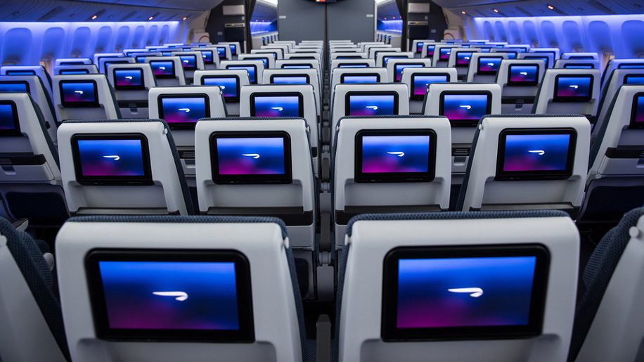 rows of seats with monitors