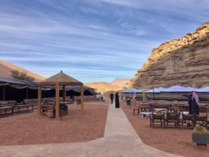 a group of tents and tables in a desert