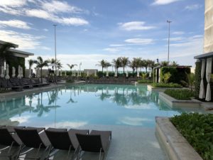 a pool with chairs and trees