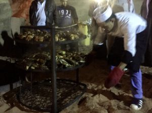 a man putting food on a rack